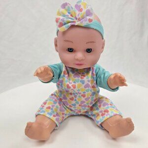 small plastic baby doll wearing a heart-patterned outfit 9"